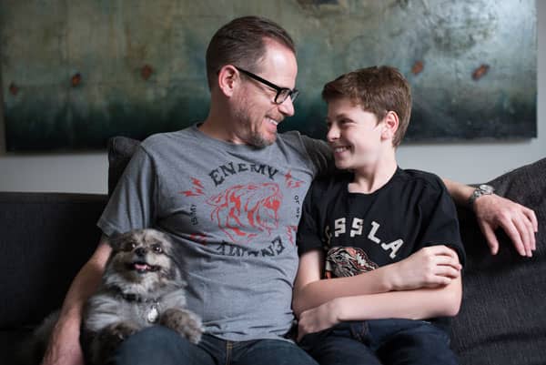 Dr. Sands seating with Son and pet dog.